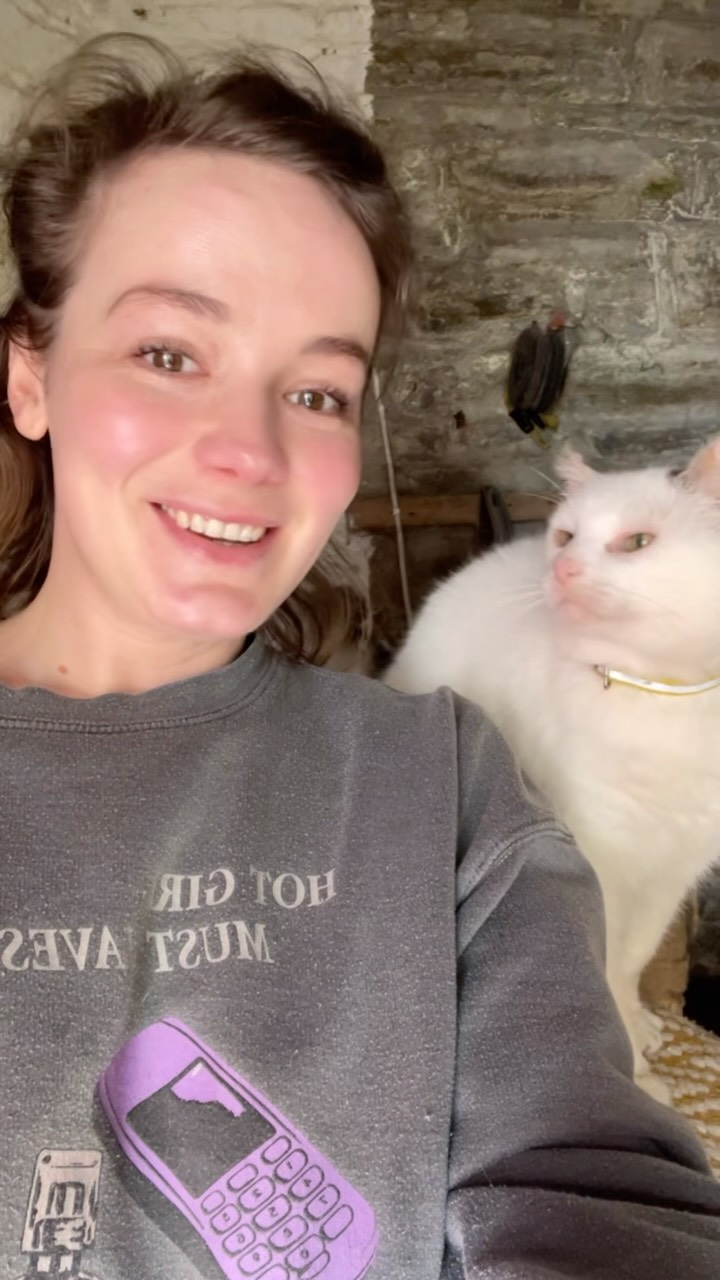 Nou with Pops, a white senior rescue cat.